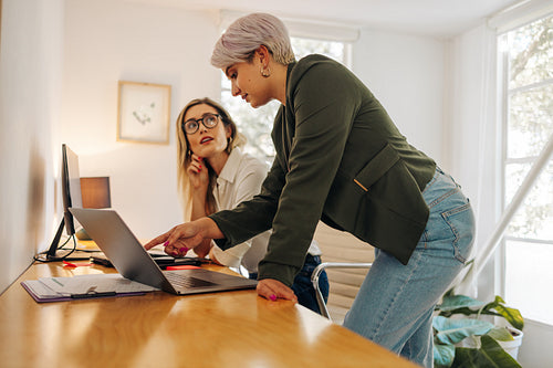Businesswoman having a discussion with her colleague in an offic
