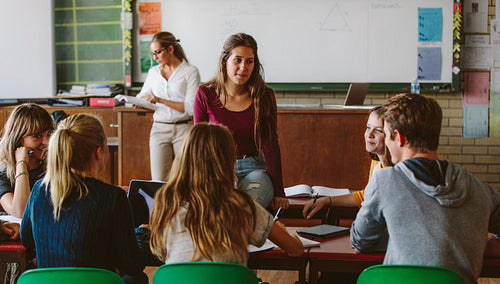 Friends study together in class room