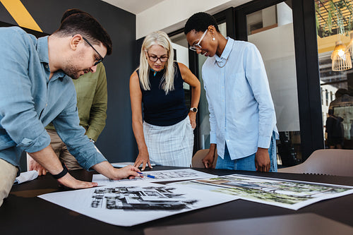 Team working on architectural project designs in modern office