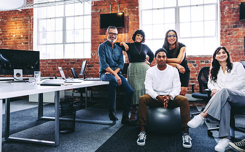Team of businesspeople smiling at the camera in an office