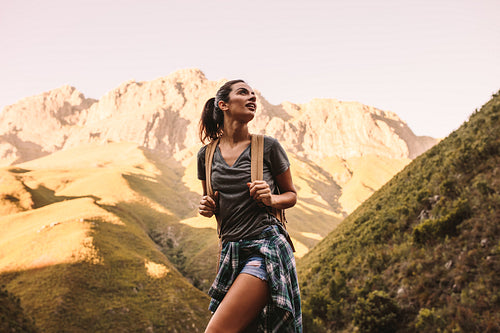 Woman hiking in mountains and looking at the scenic view