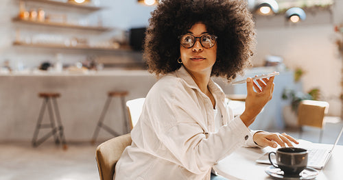 Woman making business calls in a coffee shop