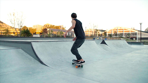Sporty young man skateboarding in a skate park