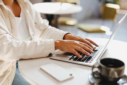 Business woman using a laptop to work in a cafe