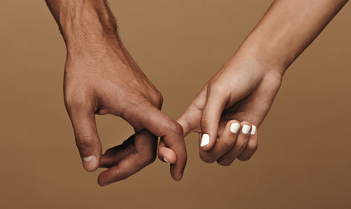 Couple linking index fingers