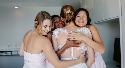 Bridesmaids congratulating the bride on wedding day
