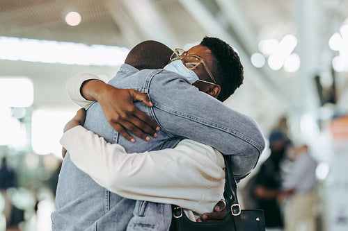 African couple reuniting at airport arrivals