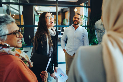 Happy businesspeople laughing cheerfully during a meeting