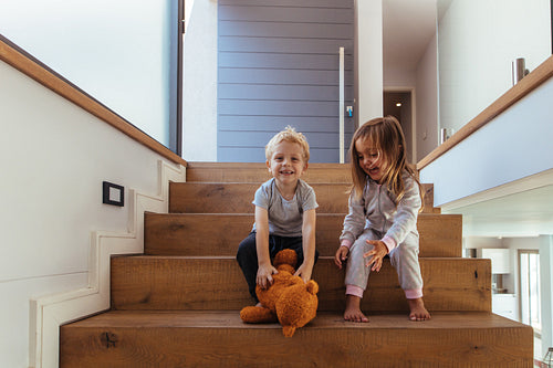 Children playing with teddy bear
