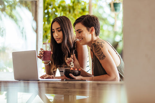 Women working on laptop at a restaurant