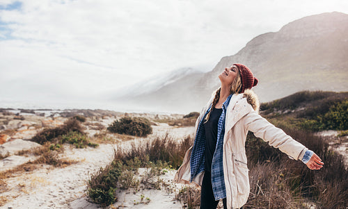 Woman happily breathing in the fresh sea air