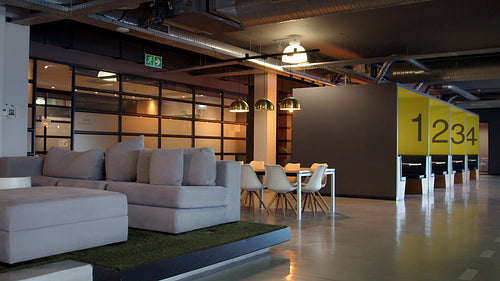 Empty coworking space with a lobby, meeting area and office cubicles