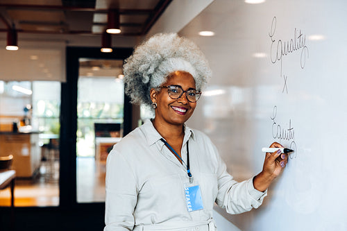 Educator writes on whiteboard during workshop