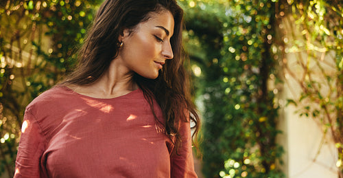 Gorgeous young woman standing in a plant tunnel