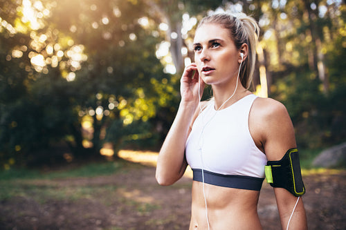 Female runner wearing earphones during workout