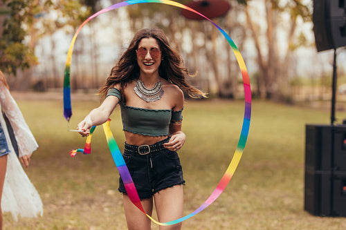 Woman playing with ribbon stick at music festival