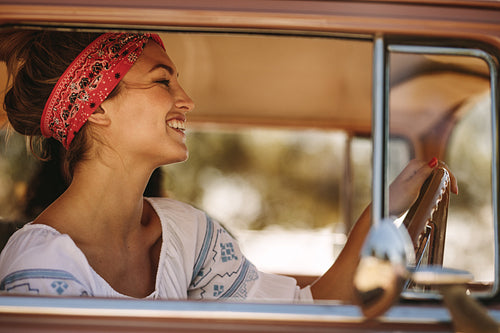 Beautiful woman driving a car and smiling