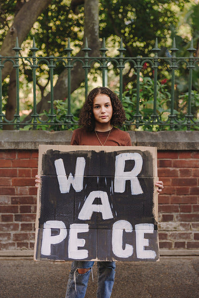 Teenage activist holding an anti-war poster