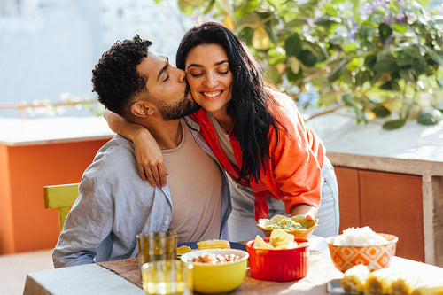Happy couple enjoying a meal together on a sunny day outdoors
