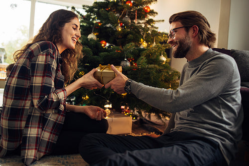Couple exchanging Christmas gifts