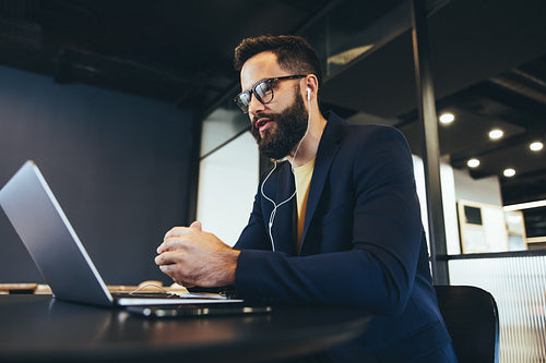 Male entrepreneur attending a virtual meeting in an office