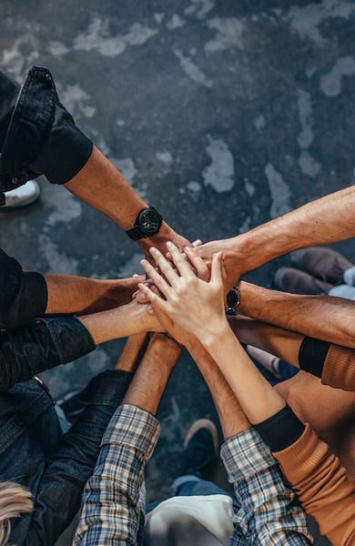 Office workers making a stack of hands