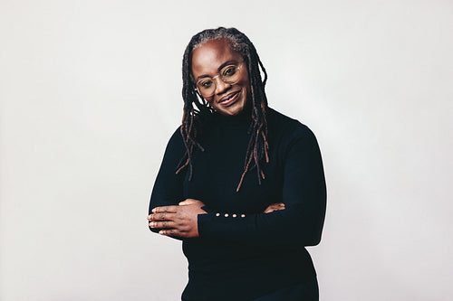 Professional mature woman smiling at the camera in a studio