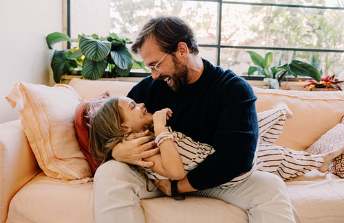 Father and daughter share joyful moment at home