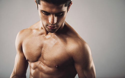 Hispanic fitness model on grey background