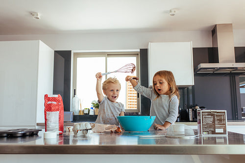 Kids having fun while making cake batter