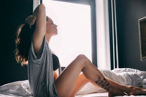 Young woman waking up in morning
