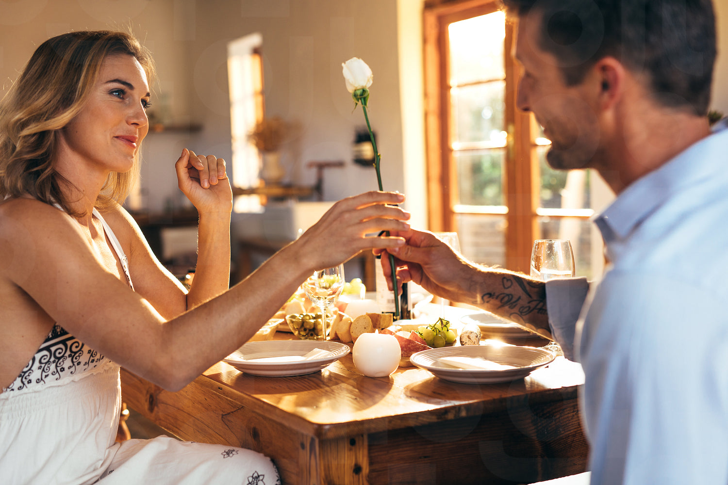 Romantic couple sitting at dining table at home