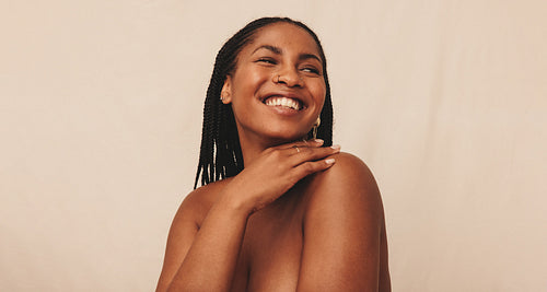 Cheerful young woman looking away with a smile