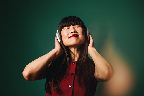 Streaming audio sets the mood as the woman listens with headphones
