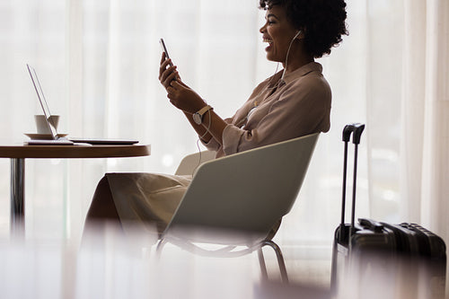 Businesswoman making video call at airport lounge