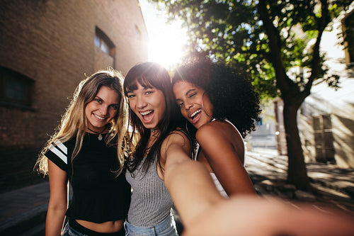 Beautiful girls hanging out in the city and making selfie