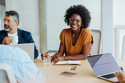 Businesswoman attending a creative brainstorming session in a modern boardroom