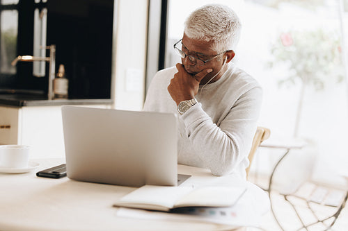 Experienced businessman working in his home office