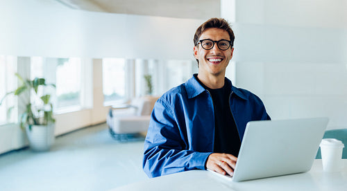 Male professional using laptop in office