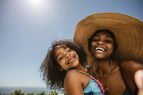 Woman taking selfie with daughter