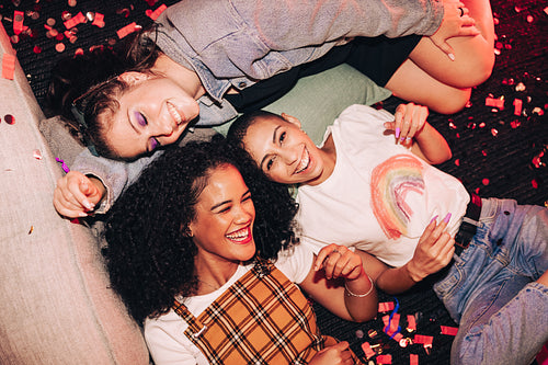 Overhead shot of happy friends lying down at a party
