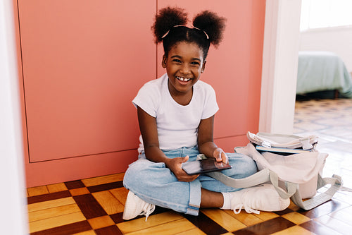 Happy young student using tablet for elearning and reading ebook at home