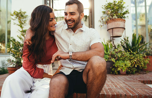 Cute couple laughing together outside a hotel