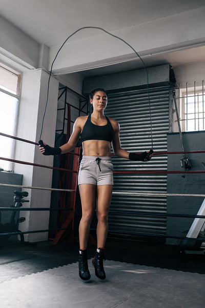 Female boxer training inside a boxing ring
