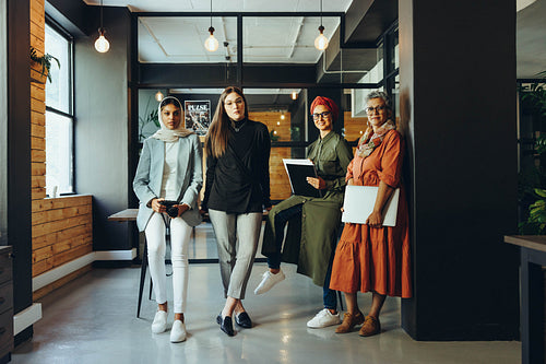 Creative female designers looking at the camera in an office
