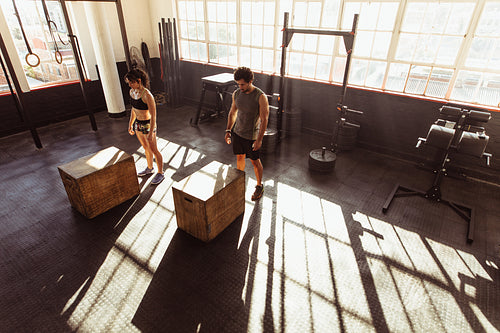 Fit young people doing box jump in gym