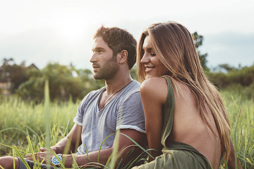 Beautiful woman sitting outdoors with her boyfriend