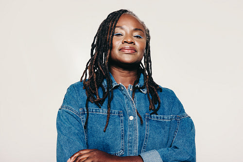Confident woman with dreadlocks looking at the camera in a studio