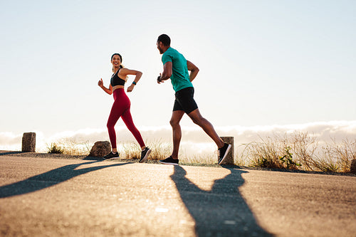 Fitness couple running on road