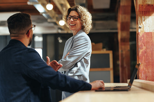 Tech professionals talking to each other in a coworking office
